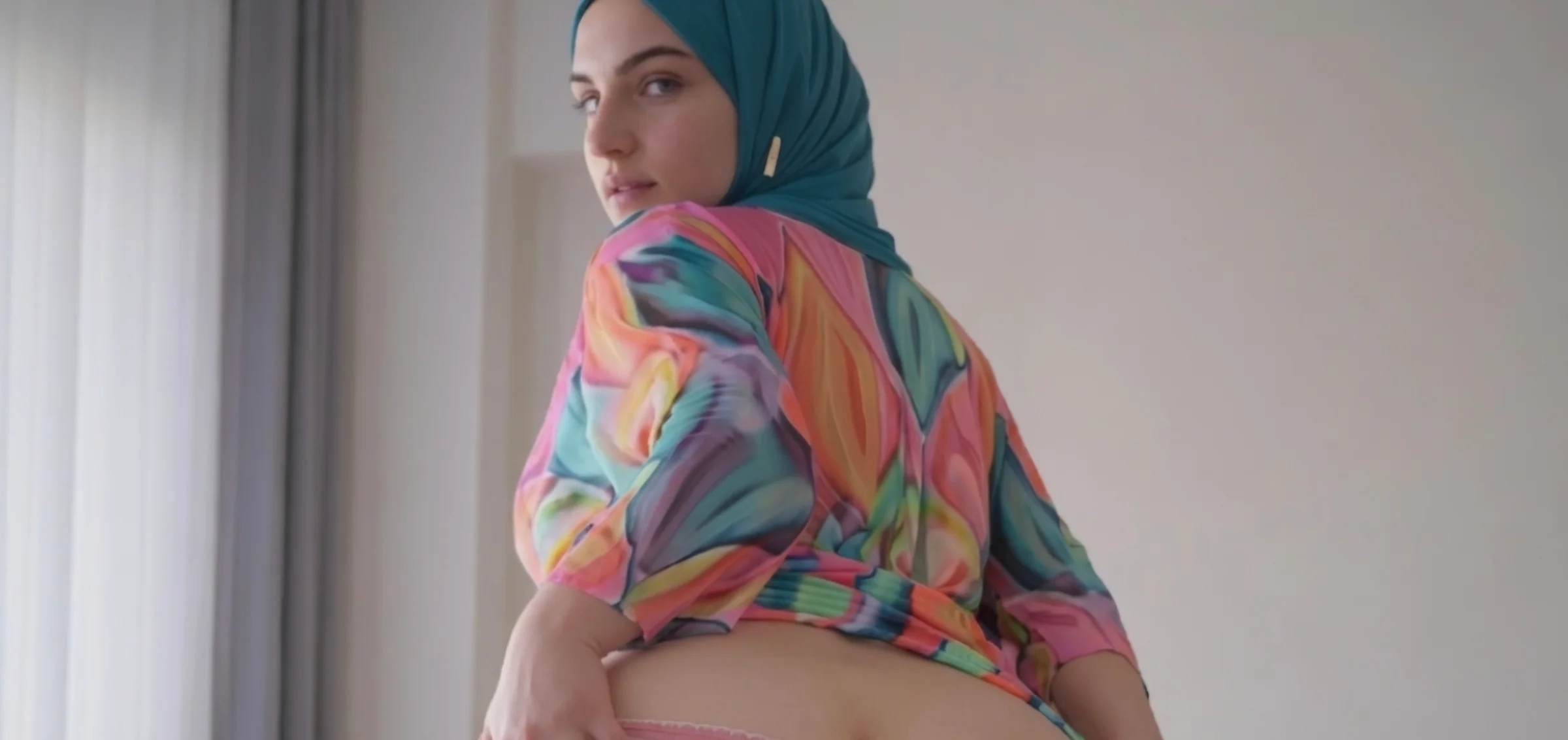 Dania Khalaf wearing a colorful outfit and teal headscarf